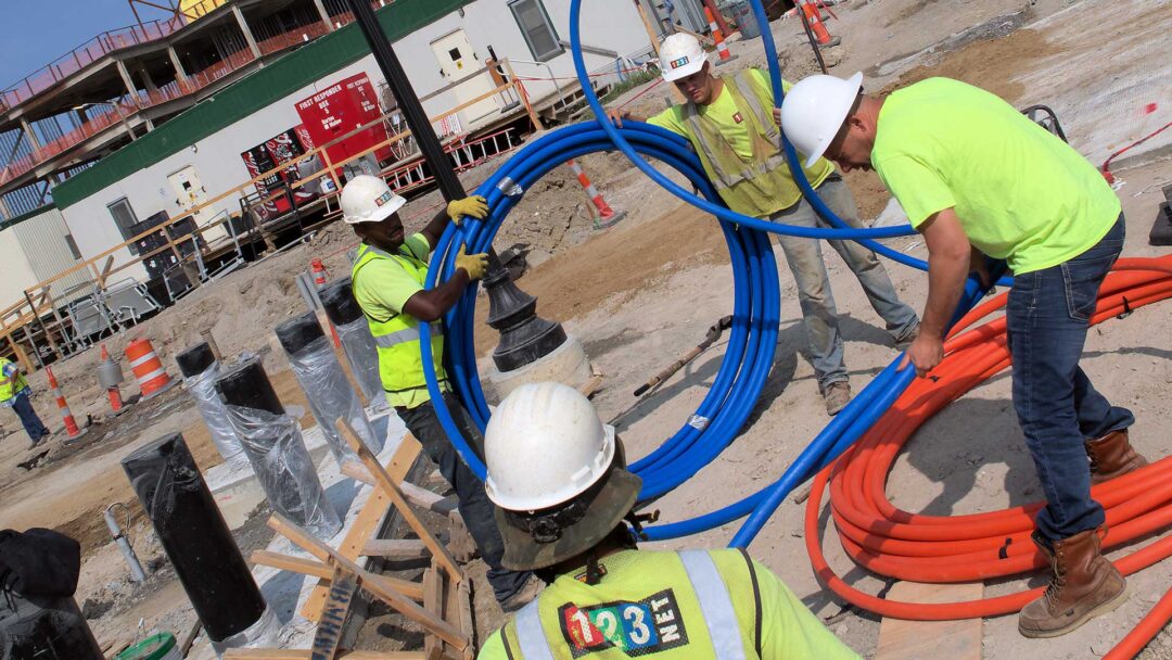 123NET workers installing a dedicated fiber network loop for business internet access in Detroit.