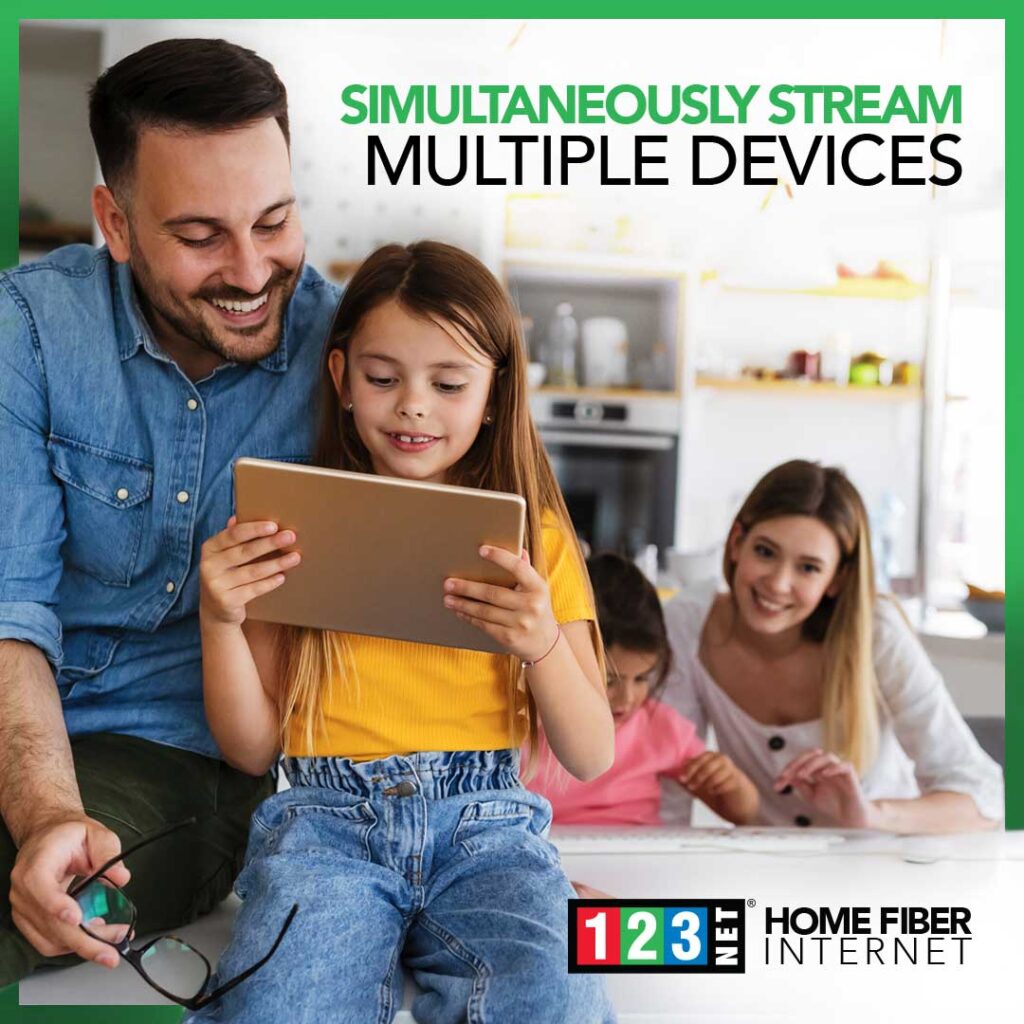 Family gathered around tablet enjoying the speed of Michigan's fastest home fiber internet connection